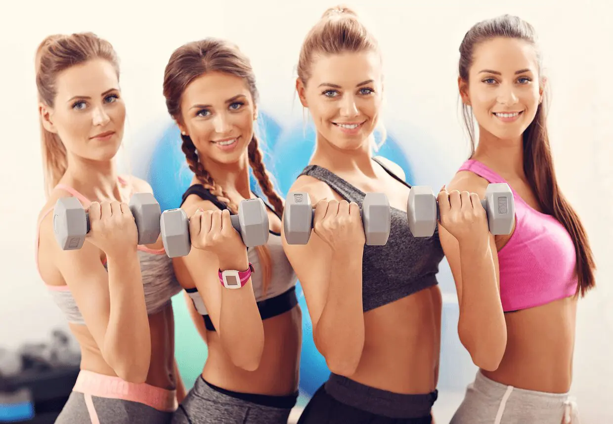 15 Women exercising with dumbbells in a gym.
